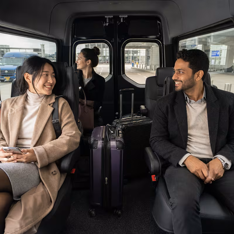 Passengers loading luggage while boarding an Paterson group shuttle