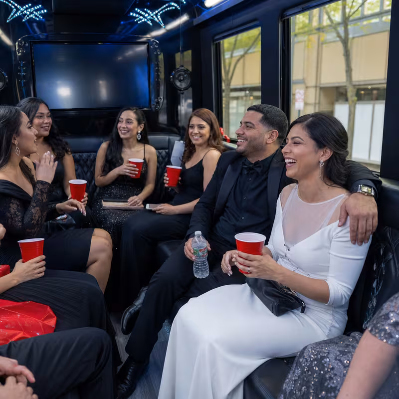Party bus interior with wraparound leather seating and LED lighting in Paterson