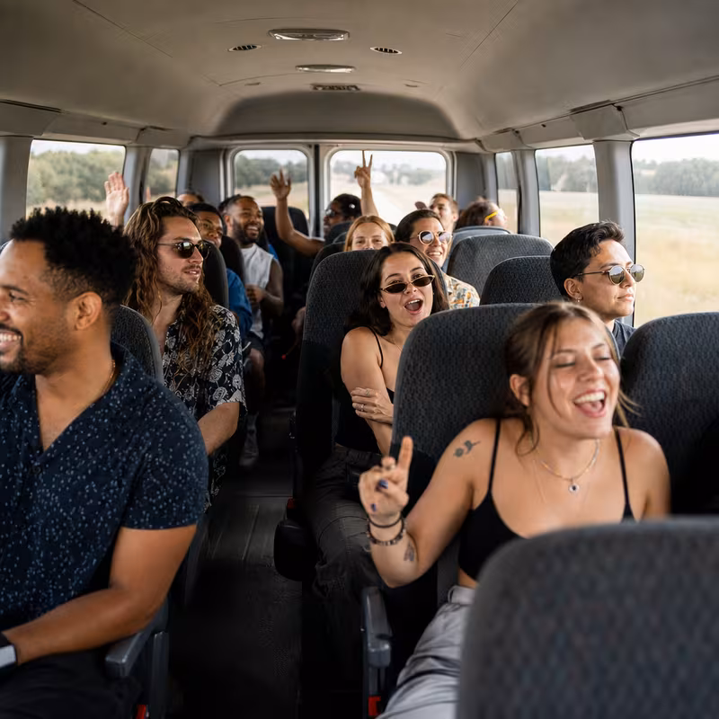 Party bus interior with wraparound leather seating and LED lighting in Paterson