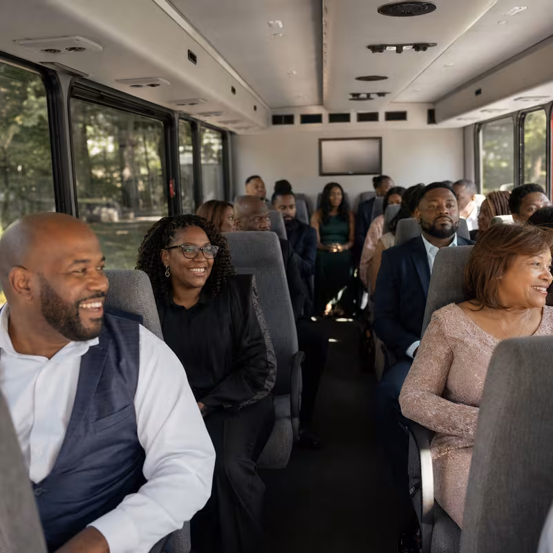 Group boarding a white charter bus for Private Event Transportation transportation in Paterson