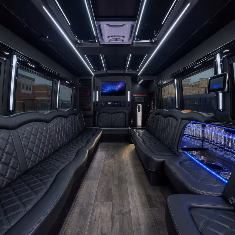 Party bus interior with wraparound leather seating and LED lighting in Paterson