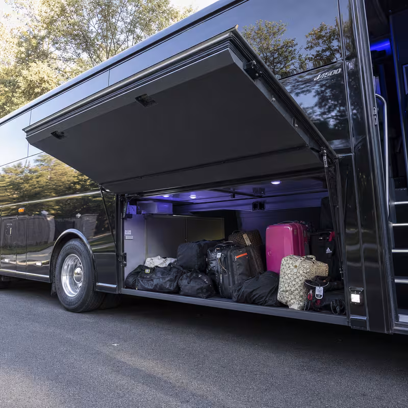 Party bus interior with wraparound leather seating and LED lighting in Paterson