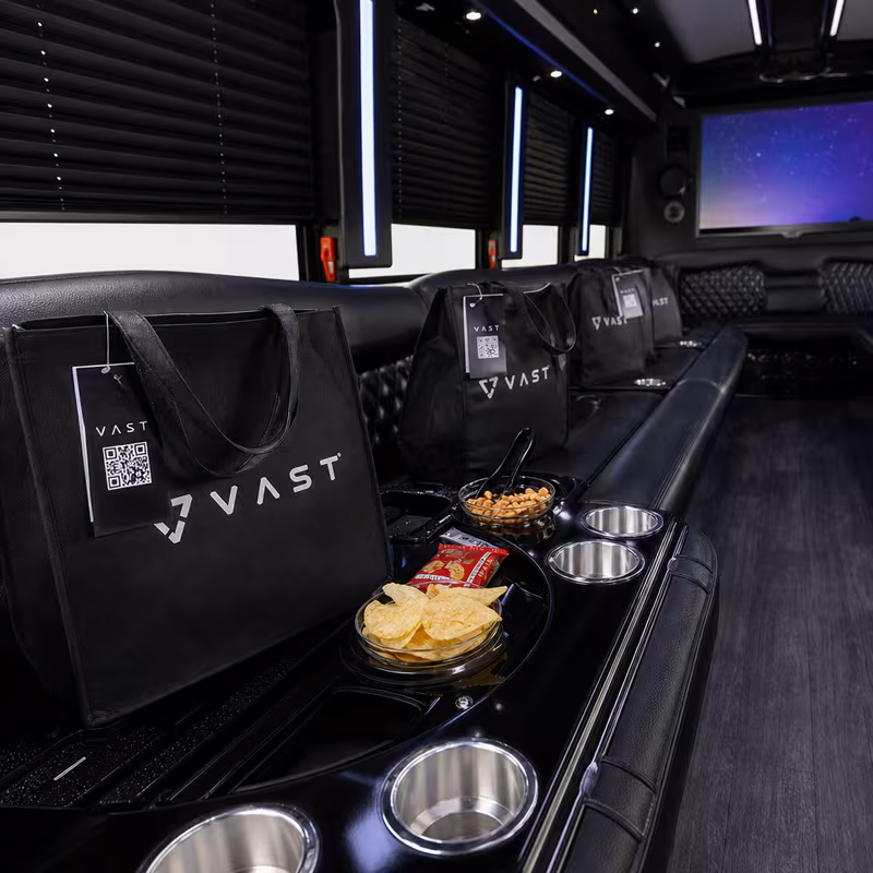 Party bus interior with wraparound leather seating and LED lighting in Paterson